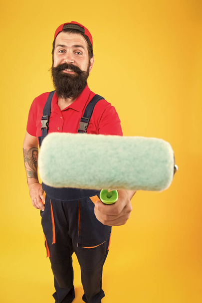 Repair and renovation. Builder regular worker hold paint roller. Perfect surface painting. Painting tool. Brush roller painter. Decoration and decor. Man bearded laborer painting in workshop - Φωτογραφία, εικόνα