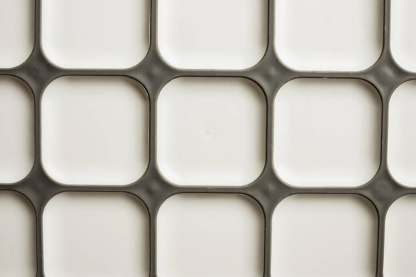 Geometrické pozadí, na bílém matném povrchu, velký šedý čtverec - Fotografie, Obrázek
