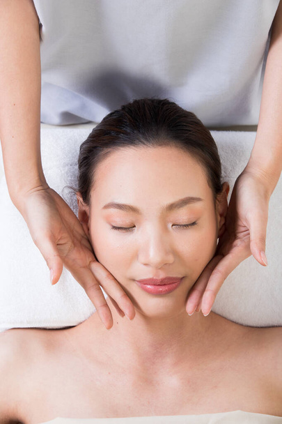 Ayurvedic Head Massage Therapy on facial forehead Master Chakra Point of Asian woman, Therapist Spa body woman hands treatment on customer to increase circulation release tension stress of think work - Photo, Image