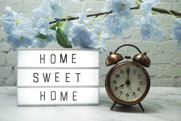 Home Sweet Home Word in light box and alarm clock with flowers decoration - 写真・画像