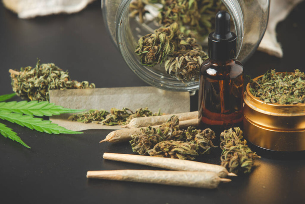 Marijuana buds with marijuana joints and Cannabis oil  - Foto, afbeelding