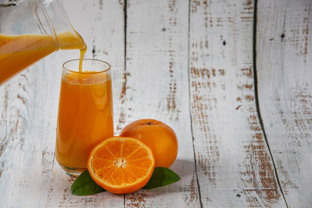  pomerančový džus nalévá pomerančový džus na sklo - Fotografie, Obrázek