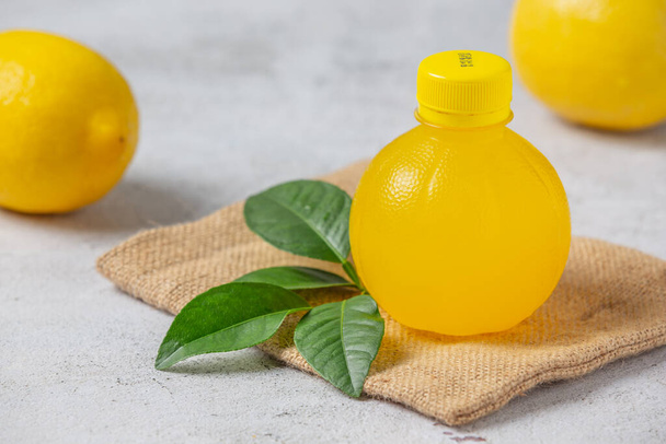 Εμφιαλωμένο χυμό λεμονιού και φρέσκα προϊόντα λεμονιού - Φωτογραφία, εικόνα
