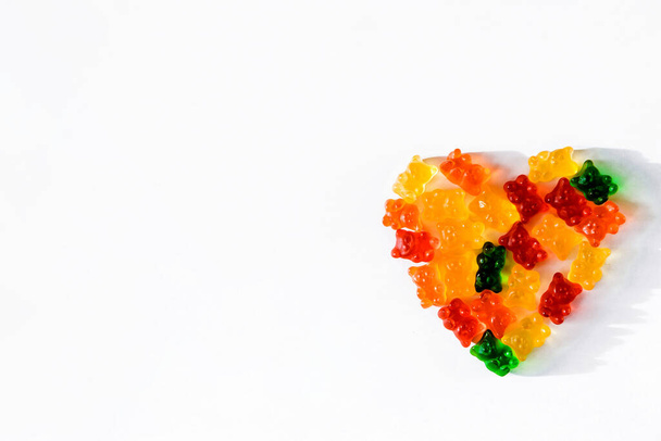 Heart shaped colored gelatins on a white background. Top view - Foto, Bild
