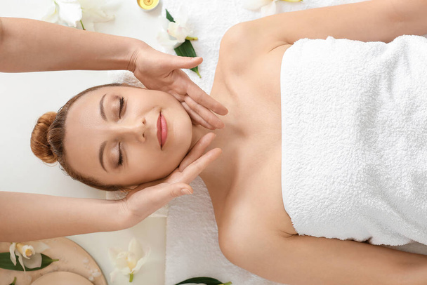 Beautiful woman receiving massage in spa salon - Фото, изображение