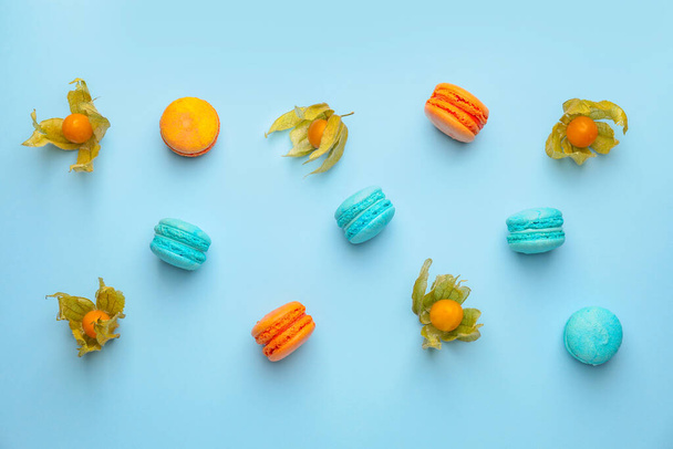 Tasty macarons with fruit on color background - 写真・画像