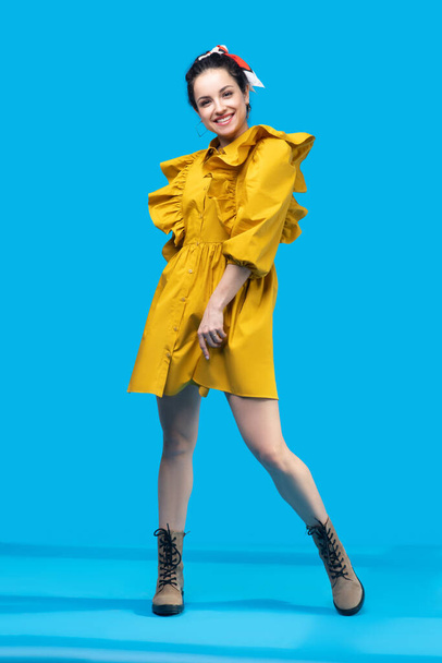 Young woman in a mustard dress looking attractive - Φωτογραφία, εικόνα