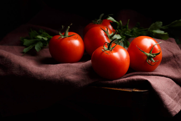 tomatoes on a dark background, still life in Dutch style, close up - Zdjęcie, obraz