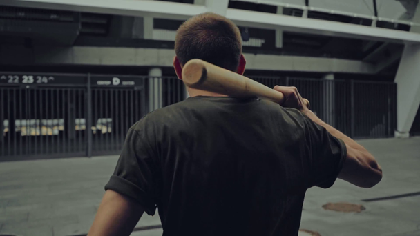 angry man with baseball bat walking on street  - Filmmaterial, Video