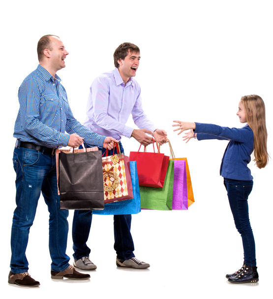Two men giving shopping bags to a girl - Foto, imagen