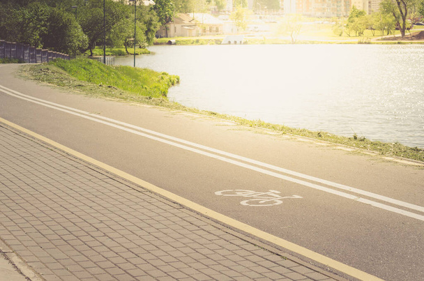 bicycle lane for exercise surround with along reservoir/bicycle lane for exercise surround with along reservoir in sunny day - Фото, зображення