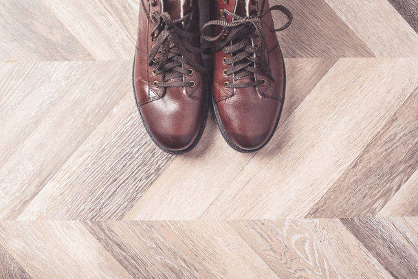 Top view of winter warm fashion male shoes on wooden background. Sale and shopping concept. Copy space. - Foto, Imagem