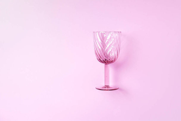 Champagne glass on pink background with copy space for text. Top view. Holiday and celebration concept. - Valokuva, kuva
