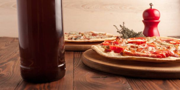 Ready-made appetizing pizza close-up. Stock photo pizza on a wooden table. - Photo, Image