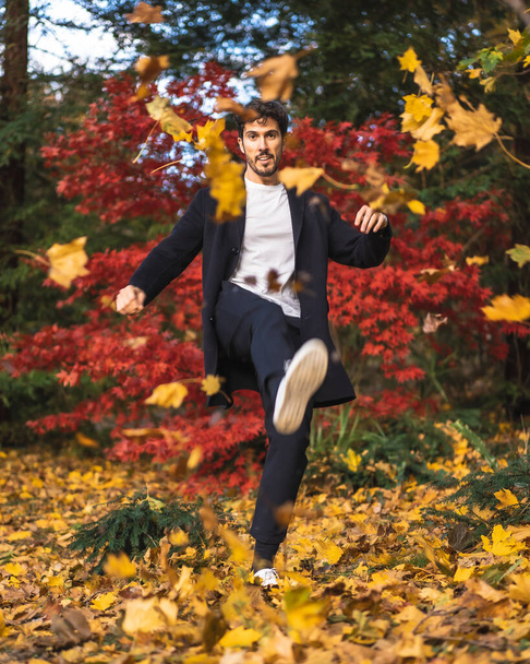 handsome young man in suit posing in autumn park - Fotografie, Obrázek