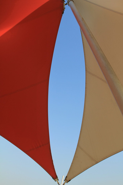 Overhead awnings on a pole against blue sky - Photo, Image