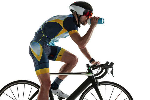 Triathlon male athlete cycle training isolated on white studio background - Фото, изображение