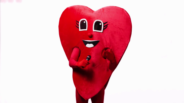 person in heart costume with microphone isolated on white - Footage, Video