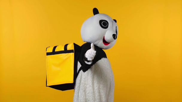 person in panda bear costume with backpack running isolated on yellow  - Footage, Video