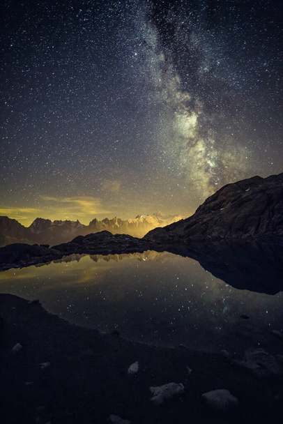 Milky Way and Starry Sky over Iconic Snowy Mont-Blanc Peaks Reflecting in Altitude Lake - Fotó, kép