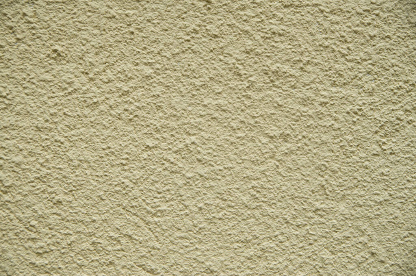 Yellow painted plaster on wall closeup - Foto, Imagen