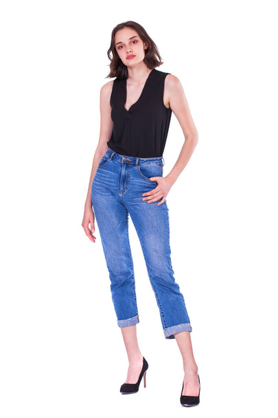 Full body portrait of a young beautiful brunette model in blue jeans, isolated on white background - Fotografie, Obrázek