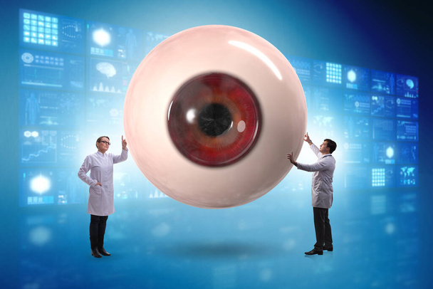 Doctor examining giant eye in medical concept - Photo, Image