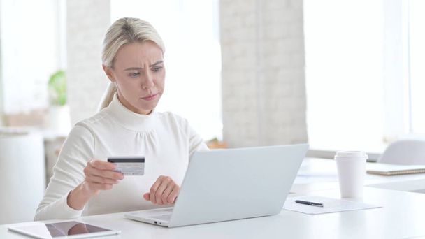Mislukt Jonge zakenvrouw gebruikt krediet op laptop - Foto, afbeelding