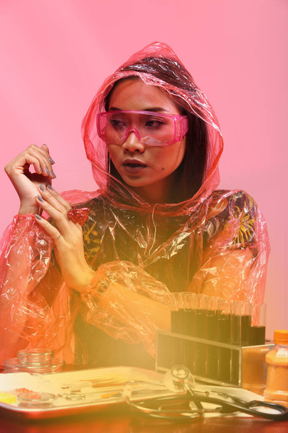 Chemistry Asian Doctor Woman with Red Tone Fashion Make up fancy lab test dress, studio lighting black dark background, safety gear hygiene hat and tube glass - Фото, зображення