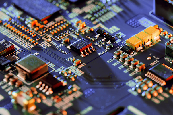 Electronic circuit board with electronic components such as chips close up.  - Foto, afbeelding