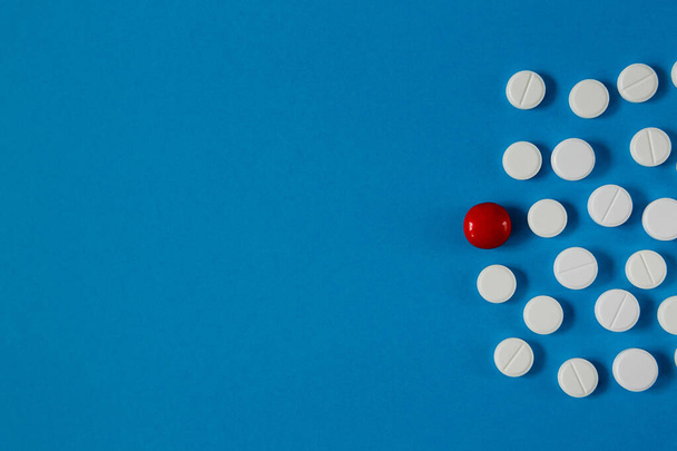 medicine and health, white and red pills on a blue background from above - Φωτογραφία, εικόνα