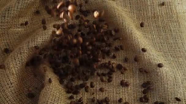 Coffee beans fall on burlap. Slow motion. - Video