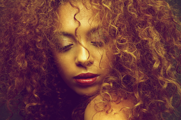 Young female fashion model with curly hair covering face - Foto, immagini