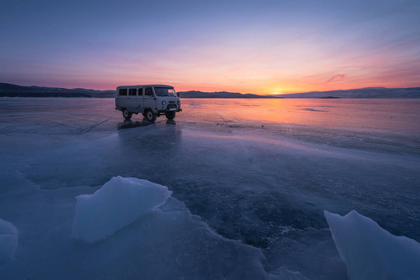 Russian van on Baikal froaen lake at sunset in winter season, Siberia, Russia, Asia - 写真・画像