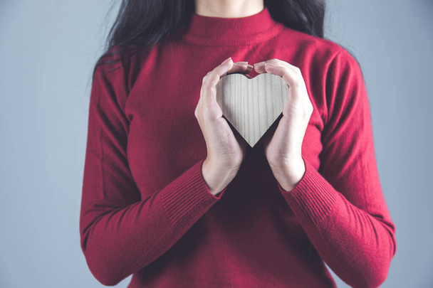 woman hand holding wooden heart  - Фото, зображення