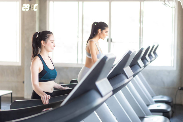 Group of women working out on treadmill at sport gym doing cardio weigh loss concept - Photo, Image