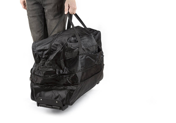 Homem de cintura para baixo segurando saco de viagem
 - Foto, Imagem