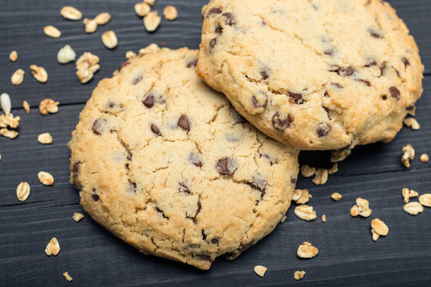 Oatmeal raisin cookies on black surface background, close up macro - Photo, Image