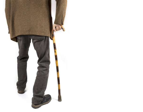 Retired man with cane in jacket on white - Foto, Bild