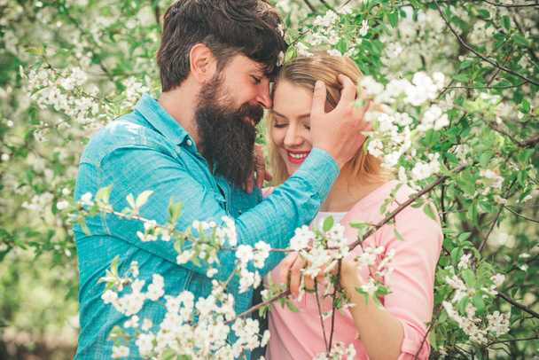 Couple on date enjoys in their lovely moments. Valentines day concept. Kissing couple in spring nature close-up portrait. - Fotoğraf, Görsel