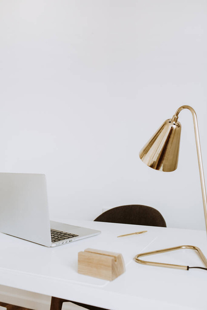 Modern minimal interior design concept. Bright Scandinavian home office desk table workspace with laptop, lamp. Business study cabinet. Girl boss studio concept. - Foto, Imagen