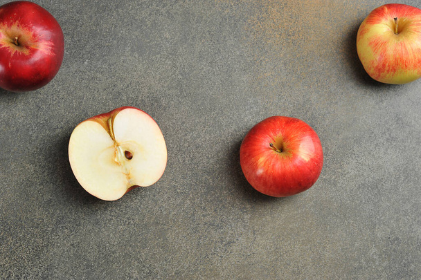 apples whole and cut on a gray background. red apples top view - 写真・画像