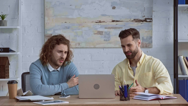happy businessmen giving high five near gadgets in office  - Footage, Video