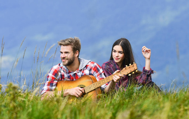 Romantic mood. Couple in love enjoying view from top of mountain. Boyfriend playing guitar. Singing for her. Romantic hike. Romantic couple on summer vacation. Idyllic place for romantic date - Zdjęcie, obraz