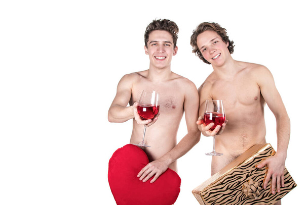 Two funny naked guys holding glasses with red wine and heart isolated on white - Foto, Imagen