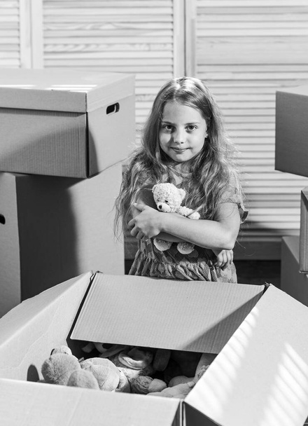 Luxury All Around. Moving concept. new apartment. happy child cardboard box. purchase of new habitation. Cardboard boxes - moving to new house. happy little girl with toy - Фото, изображение