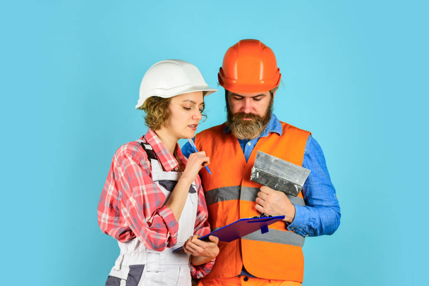 how new home is being built. Worker show house design. couple discussing blueprint at home. real estate deal. talk about interior decoration. under construction. looking at construction house plan - Photo, image