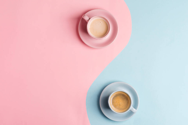 Creative pastel blue pink background as a symbol of infinity with two ceramic cups of freshly brewed coffee drink. - Fotó, kép