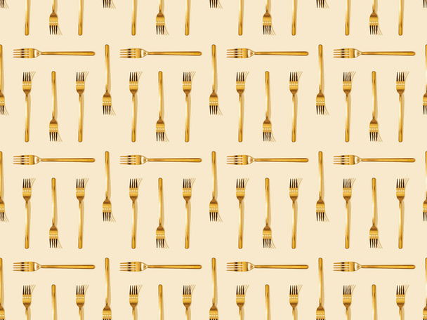 top view of golden forks on beige, seamless background pattern - Photo, Image