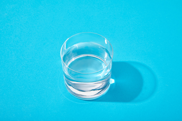 glass of fresh water on blue background - Photo, Image